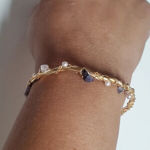 Gold wire wrapped bracelet featuring stones